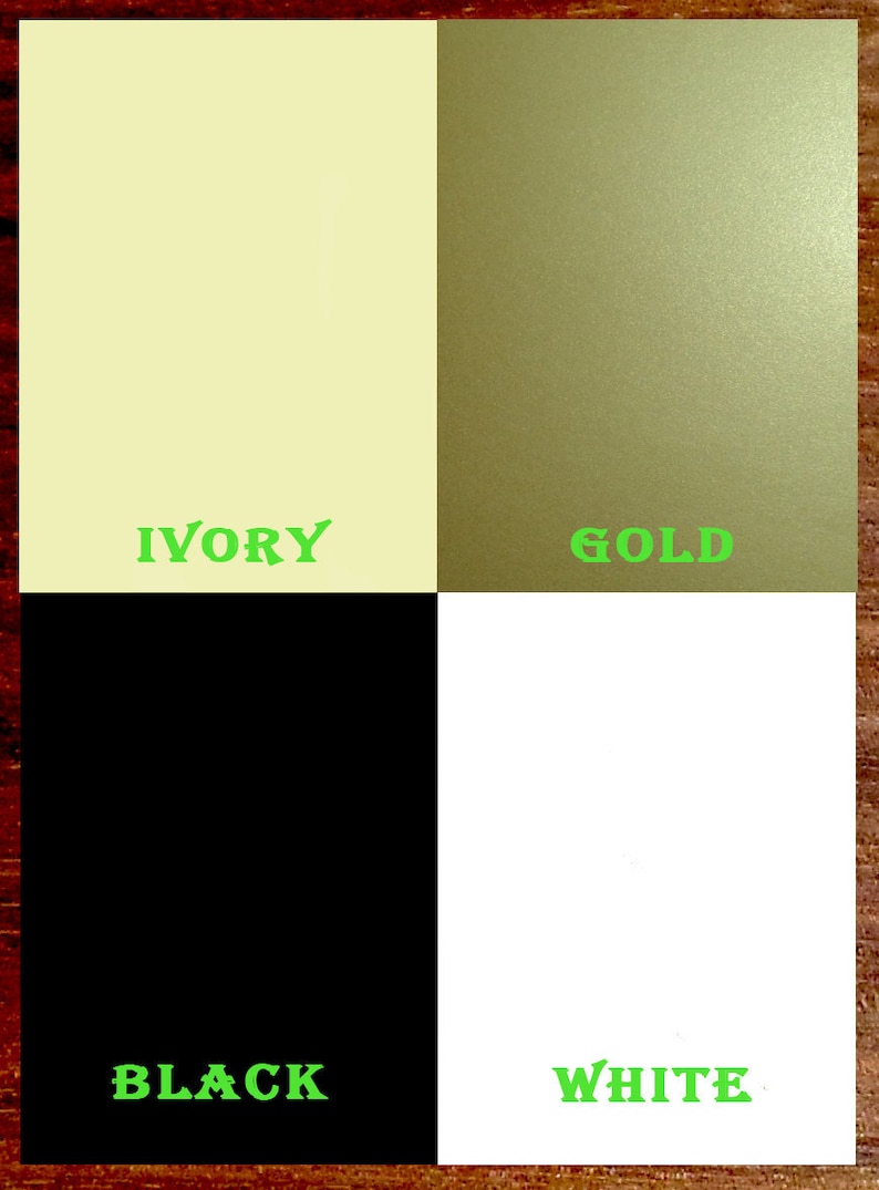 May include: A color chart with four squares showing the colors ivory, gold, black, and white.
