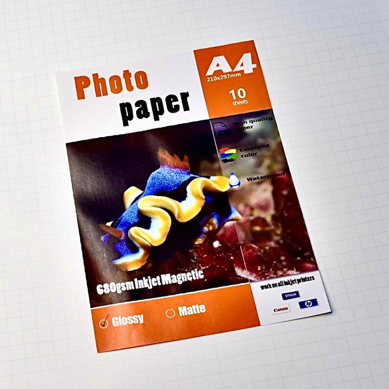 May include: A package of 10 sheets of A4 photo paper, 680gsm Inkjet Magnetic, with a glossy finish. The paper is suitable for use with all inkjet printers, including Canon and Epson. The package features an image of a colorful sea slug.