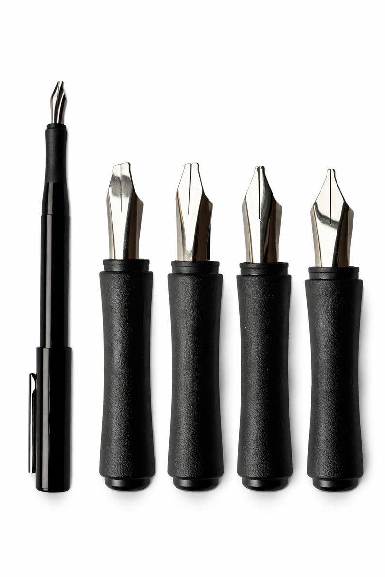 May include: A black fountain pen with a silver nib is shown alongside four black pen nib holders with silver nibs. The writing instruments are arranged on a white background, highlighting the design and craftsmanship of the pens.
