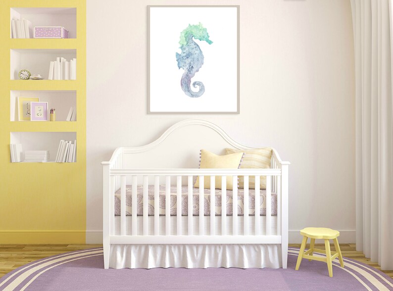 May include: A white crib with a white ruffle skirt and a purple and white patterned sheet. A yellow stool is in the corner of the room. A watercolor painting of a blue and green seahorse is hanging on the wall above the crib.