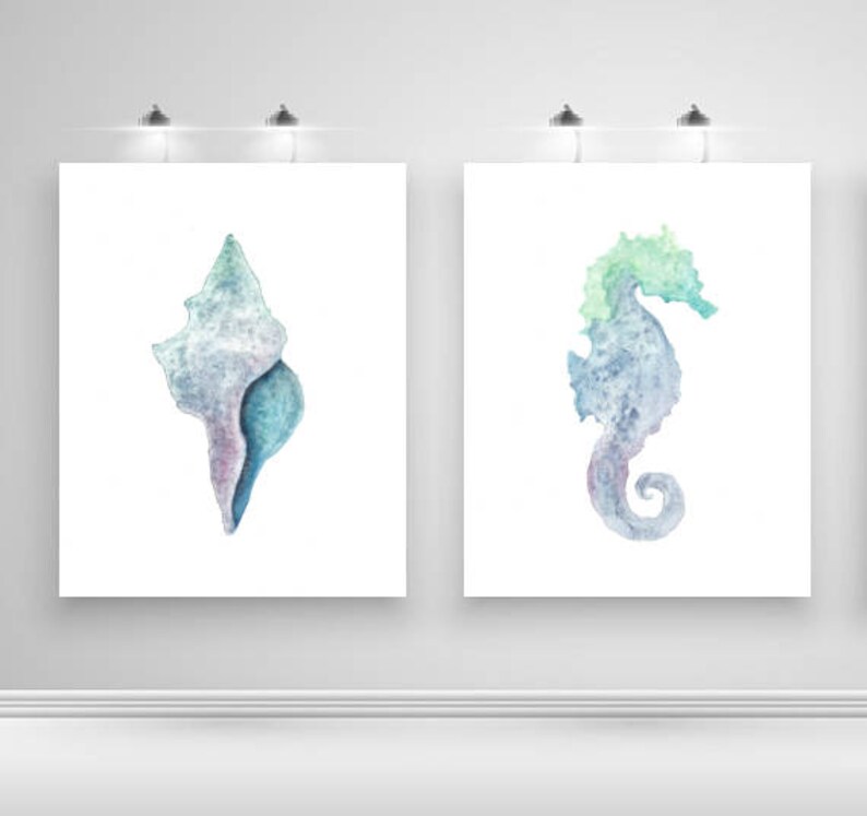 May include: Two watercolor paintings on canvas, one depicting a seashell in shades of blue and purple, the other a seahorse in shades of blue, green, and purple.