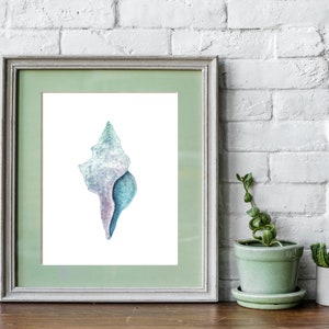 May include: A watercolor painting of a seashell in shades of blue, purple, and white. The seashell is framed in a light green frame.