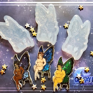 May include: Three clear silicone molds for making resin fairy figurines. The molds are shaped like fairies with wings and are sitting on a stool. The molds are on a dark blue background with gold stars.