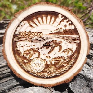 May include: A round wooden coaster with a detailed laser-etched design. The design features sea turtles swimming in the ocean, a sunset, and the date 10/5/2009. The coaster also includes the text "SELF, GOD, SERVICE" and the Roman numeral XV.