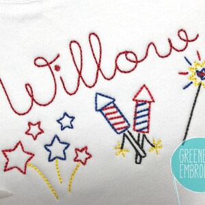 May include: Embroidered design featuring the name "Willow" in red thread, with fireworks and stars in red, white, and blue. The design is on a white fabric background.