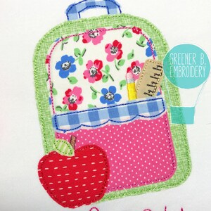May include: A green and pink fabric applique of a backpack with a red apple and a pencil and ruler in the pocket. The backpack has a floral pattern and a blue and white checkered pocket.