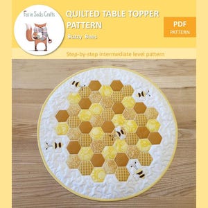 May include: A quilted table topper pattern featuring a honeycomb design with bees. The pattern is titled "Buzzy Bees" and is described as a step-by-step intermediate level pattern.