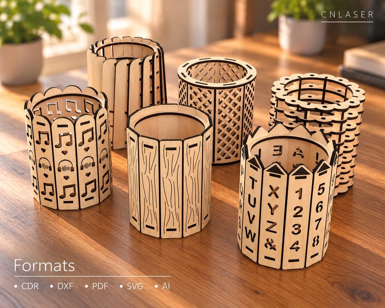 May include: Six cylindrical wooden pen holders with laser-cut designs including musical notes, headphones, hearts, a lattice pattern, wood grain textures, and alphanumeric characters. The text CNLASER is visible in the top right corner.