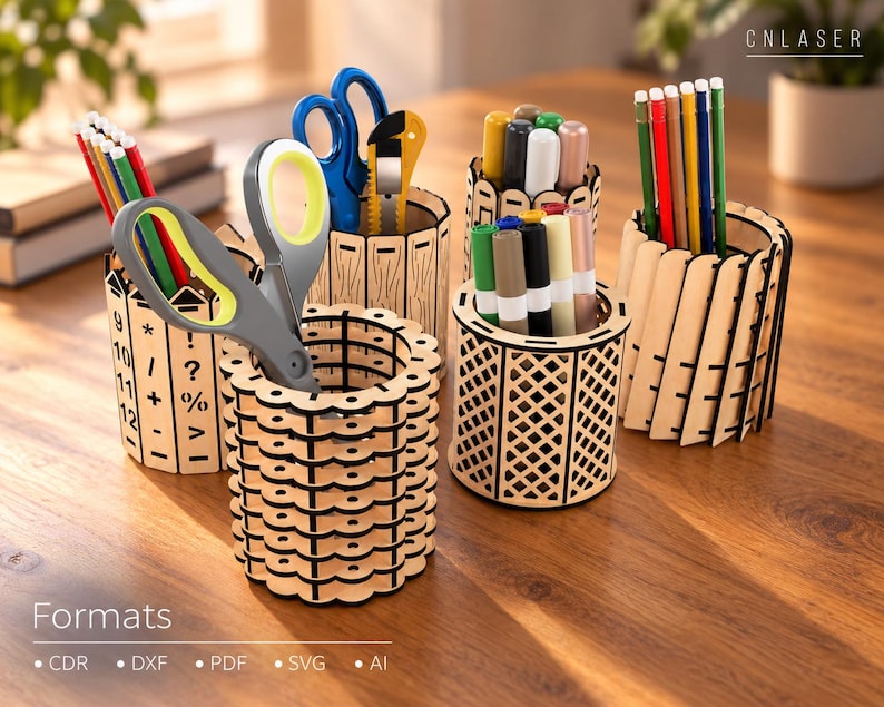 May include: A collection of four cylindrical wooden pencil holders with laser-cut designs, including one with mathematical symbols and numbers, filled with various colored pencils, markers, and scissors. The text CNLASER and Formats CDR DXF PDF SVG AI are visible.