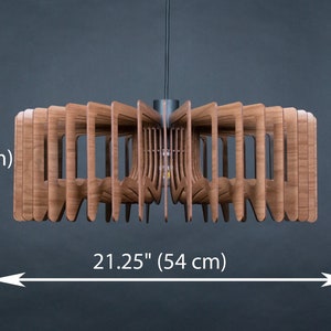 May include: A wooden pendant light fixture with a geometric design. The light is 7.48 inches tall and 21.25 inches wide.