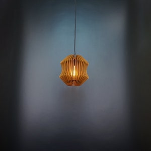 May include: A wooden pendant light with a geometric design. The light is on and casts a warm glow.