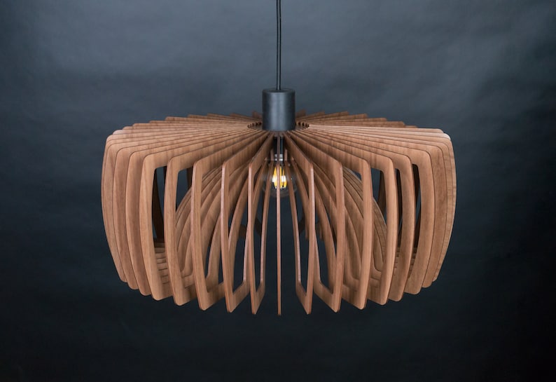 May include: A modern wooden pendant light fixture with a black metal canopy and a warm light bulb. The light fixture is made of thin, curved wooden slats that create a unique and stylish design.