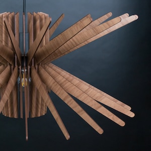 May include: A wooden ceiling light fixture with a circular base and multiple wooden slats extending outwards, creating a starburst pattern.