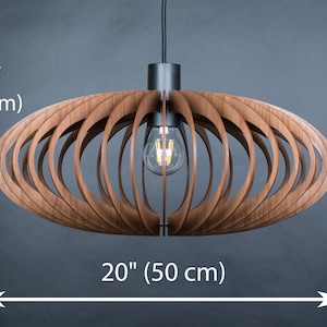 May include: A wooden pendant light fixture with a circular, open-weave design. The light fixture is 20 inches wide and 8 inches tall.