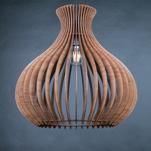 May include: A wooden pendant light fixture with a bulb visible inside. The light has a unique design, with vertical wooden slats forming a bulbous shape. The fixture is suspended from a wire against a dark gray background.