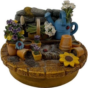 Our America Candle Topper Gardening Scene Flowers Watering Can Hose Pots Tools Bench Vintage
