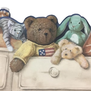 May include: A decorative wall border featuring a painted illustration of a gray striped cat, a brown teddy bear wearing a yellow sweater with an American flag design, a light green rabbit, and a small tan teddy bear resting on a white dresser.