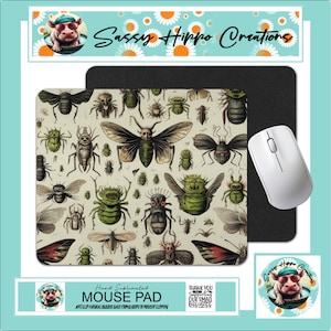 May include: A rectangular mouse pad with a beige background featuring a pattern of various insects in green, black, and beige. A white computer mouse sits to the right of the mouse pad. The text "MOUSE PAD" is visible.