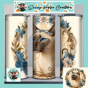 May include: A set of three insulated tumblers featuring a Siamese cat design. The cat has blue eyes and wears a floral crown. The tumblers are cream-colored with blue and white floral accents and the text "Sassy Hippo Creations".