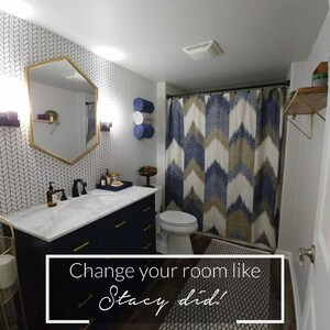 May include: A bathroom with a navy blue vanity, white marble countertop, and gold hardware. The bathroom has a white chevron patterned wallpaper, a white toilet, and a shower with a blue and brown geometric patterned shower curtain. The text "Change your room like Stacy did!" is on a black and white patterned rug.