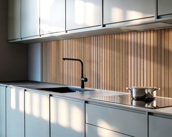 May include: A modern kitchen with white cabinets, a stainless steel sink, and a black faucet. The backsplash is made of wood slats.