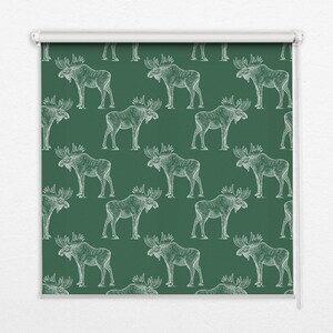 May include: A green fabric roller blind with a white moose pattern. The moose are drawn in a vintage style and are repeated throughout the fabric.