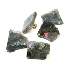 May include: Five iridescent labradorite crystal drawer pulls with a gold finish. The crystals are various shapes and sizes.