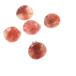 May include: Five round, red and white agate knobs with a silver screw on the back.