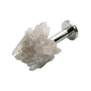 May include: A decorative crystal curtain tieback with a cluster of light-colored quartz crystals. The crystals are attached to a silver-colored metal rod and a circular base. The tieback is designed to hold curtains.