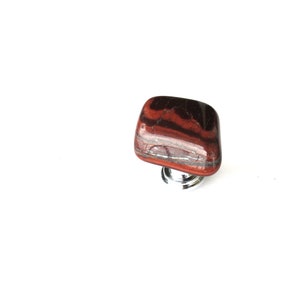 May include: Red tiger's eye stone cabinet knob with a silver base.