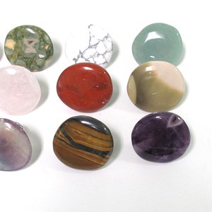K&ouml;nnte beinhalten: Sortiment von 12 glatten, runden, polierten Steinen in verschiedenen Farben und Mustern. Die Steine sind in einem Kreis auf wei&szlig;em Hintergrund angeordnet.
