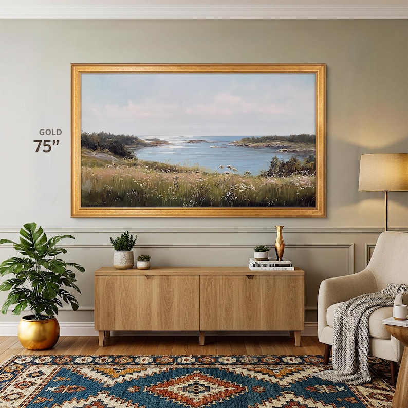 gold samsung frame 75 inch on the sage green light wall, custom frame for tv, boho inspired interior with a light wooden tv console, abstract eclectic carpet