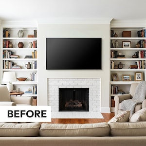 white american standard living room with white brick fireplace and black inside, built in white bookshelves with orange stained wooden floors before