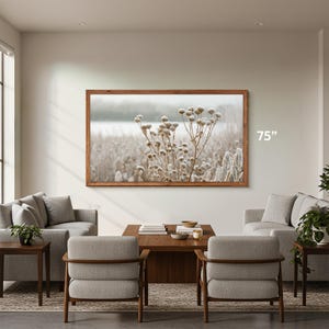Samsung The Frame wooden tv bezel 75 inch on the living room wall, early american wooden coffe table with matching gray living room chairs, nature macro tv art of frozen flowers, tv frame thin 55 frame tv wood frame