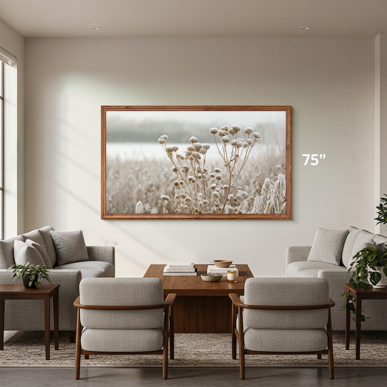 Samsung The Frame wooden tv bezel 75 inch on the living room wall, early american wooden coffe table with matching gray living room chairs, nature macro tv art of frozen flowers, tv frame thin 55 frame tv wood frame