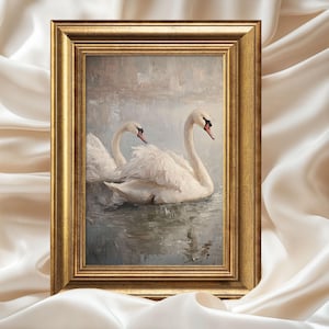 May include: A framed painting of two white swans swimming in a misty lake. The swans are facing each other, with their necks curved gracefully. The painting is done in a realistic style, with soft brushstrokes and muted colors.