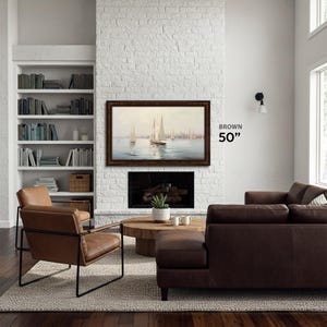 country farmhouse decoration brown wood tv frame 50 inch on a white brick wall, sailor tv art in the tv bezel tcl nxtvision 50, dark brown leather couch