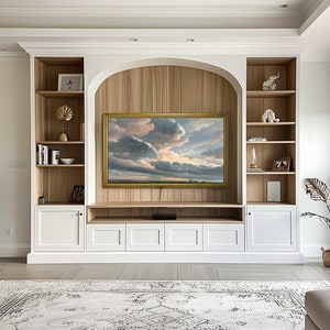 Samsung bezel frame in light interior with white cabinetry and golden decors