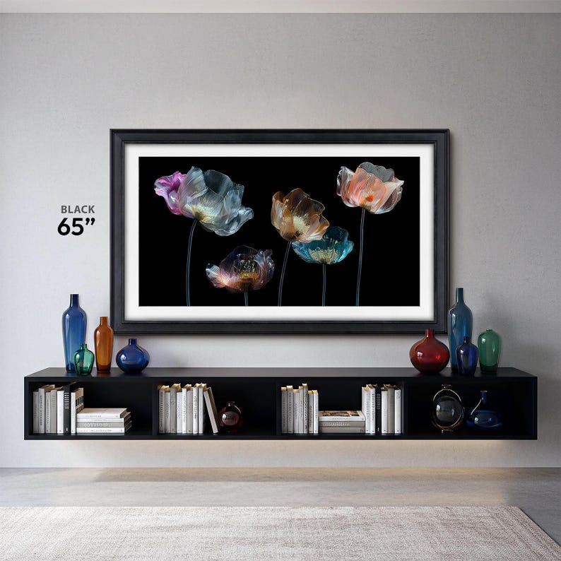 the frame tv frames 65 inch black tv bezel Samsung the frame contemporary in a modern living room, black tv console with modern black and translucent flower tv art with white mat, decorative glass bottles and vases on the tv console