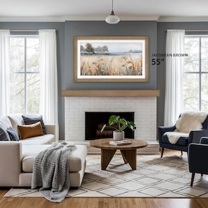 jacobean frame tv 55 Samsung The Frame bezel on a gray wall with white fireplace and natural wood mantel, american style living room with scandinavian touch