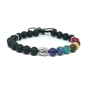 May include: Black lava rock beaded bracelet with a silver Buddha charm and seven chakra stones in red, orange, yellow, green, blue, indigo, and violet.