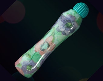 May include: A green and white floral patterned marker with a teal cap.