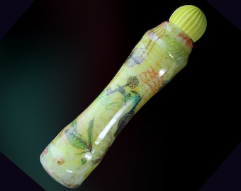 May include: A yellow marker with a floral and bird design. The marker has a yellow cap with a textured top.