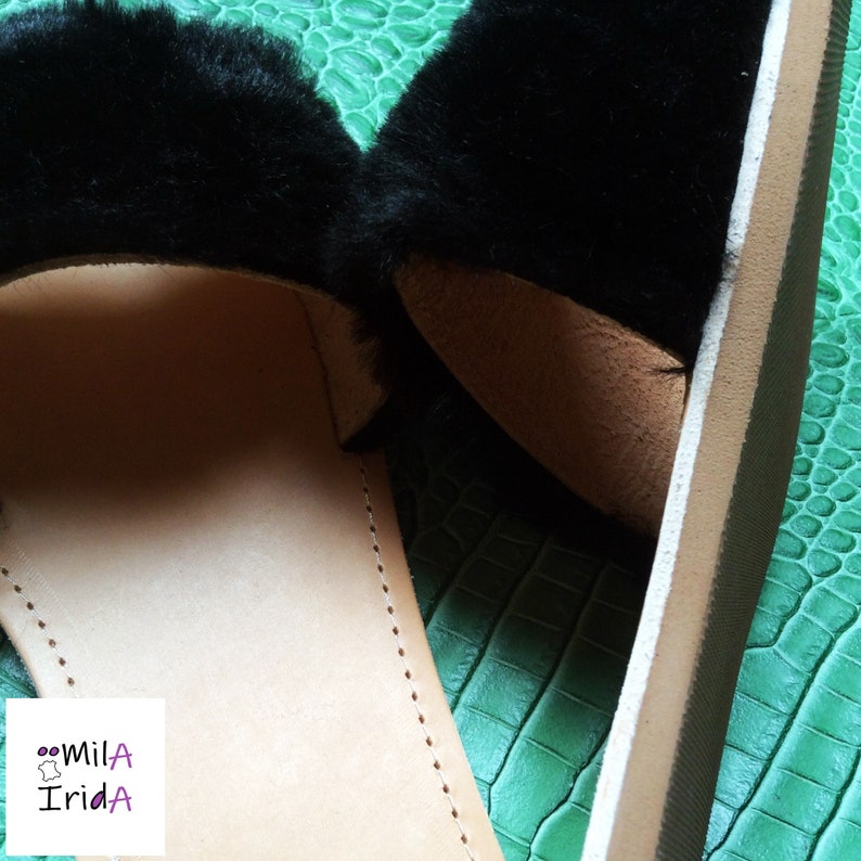 Cowhide and faux fur mules.