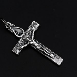 May include: Silver-toned metal crucifix pendant with a figure of Jesus Christ and the words "In Loving Memory" engraved on the cross.