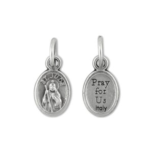May include: Silver charm featuring an oval pendant with an image of Saint Jude Thaddeus on one side and the text "Pray for Us Italy" on the other side.