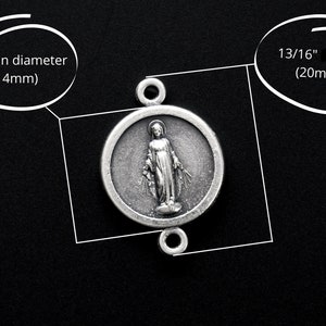 May include: Silver charm featuring a depiction of the Virgin Mary, 9/16" in diameter (14mm) and 13/16" long (20mm).