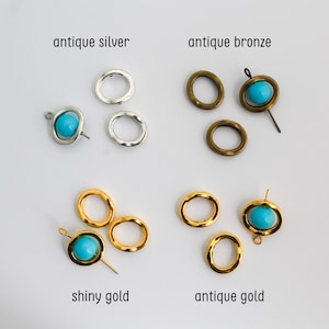 May include: Jewelry components in four finishes: antique silver, antique bronze, shiny gold, and antique gold. Each set includes plain metal rings and rings featuring a central bright turquoise bead held by a thin metal pin through the center.