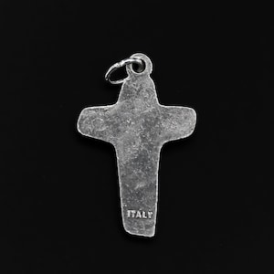 May include: Silver cross charm with a textured surface and the word "ITALY" inscribed on the bottom.