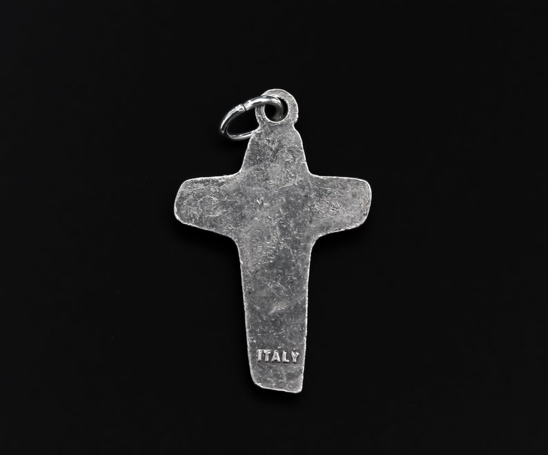 May include: Silver cross charm with a textured surface and the word "ITALY" inscribed on the bottom.